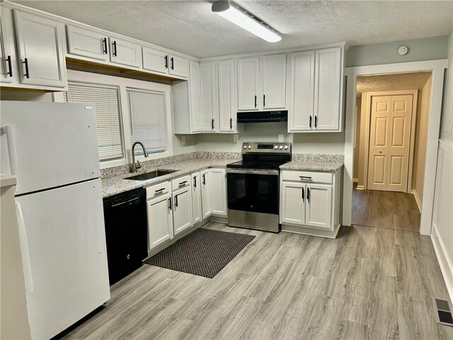 kitchen featuring light hardwood / wood-style floors, white cabinetry, stainless steel electric stove, white fridge, and dishwasher