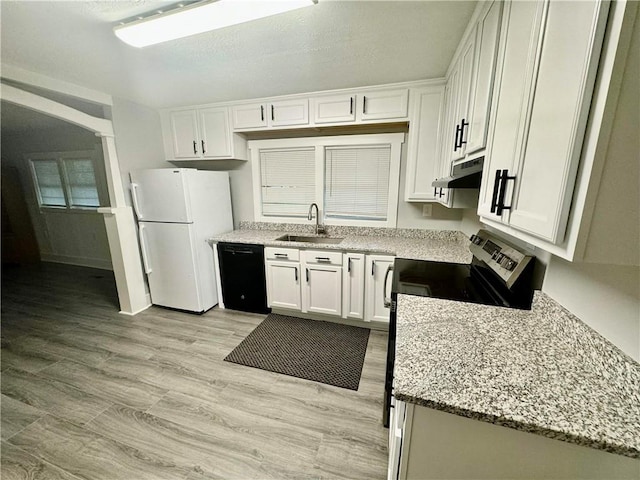 kitchen featuring dishwasher, white cabinets, sink, white fridge, and light wood-type flooring