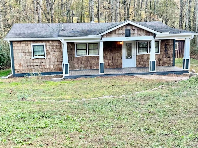 ranch-style home with a porch and a front lawn