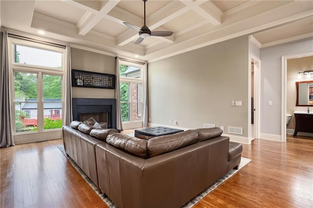 2260 Falkirk Pointe Dr, Marietta, GA 30062 - living room featuring wood finished floors, crown molding, beamed ceiling, a ceiling fan, and a large fireplace