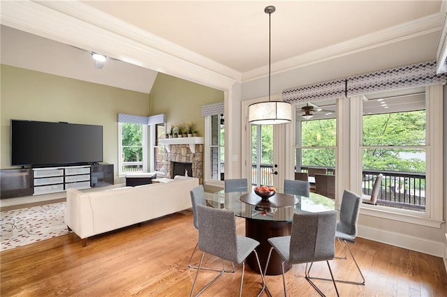 2260 Falkirk Pointe Dr, Marietta, GA 30062 - dining room with vaulted ceiling, crown molding, a fireplace, light wood finished floors, and a ceiling fan