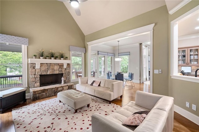 2260 Falkirk Pointe Dr, Marietta, GA 30062 - living room with ceiling fan, ornamental molding, wood finished floors, high vaulted ceiling, and a stone fireplace