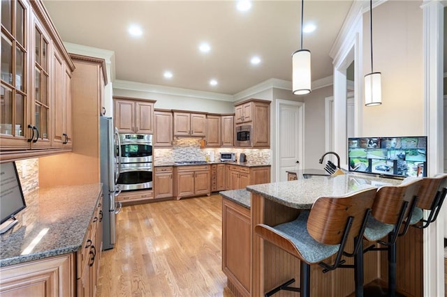 2260 Falkirk Pointe Dr, Marietta, GA 30062 - kitchen with appliances with stainless steel finishes, decorative backsplash, a breakfast bar area, a peninsula, and stone counters