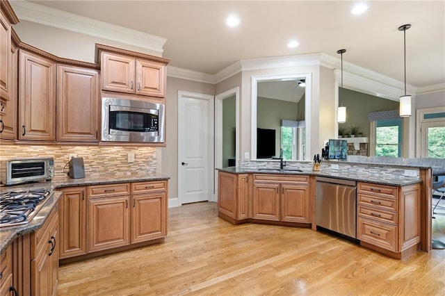 2260 Falkirk Pointe Dr, Marietta, GA 30062 - kitchen with stainless steel appliances, light wood-style floors, backsplash, dark stone countertops, and pendant lighting
