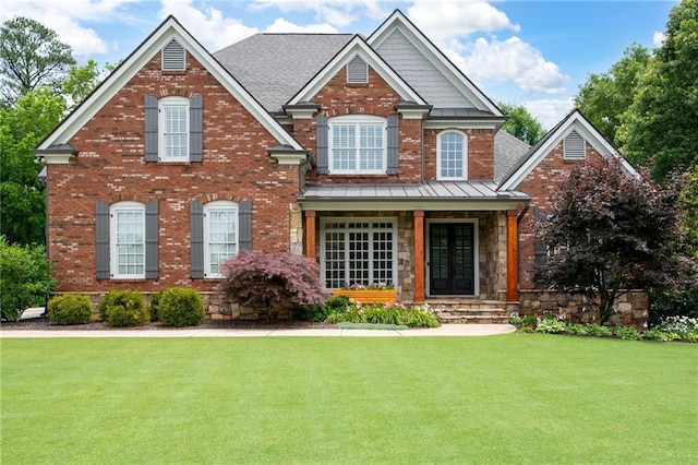 2260 Falkirk Pointe Dr, Marietta, GA 30062 - view of front of property featuring a front yard, a standing seam roof, brick siding, a porch, and stone siding