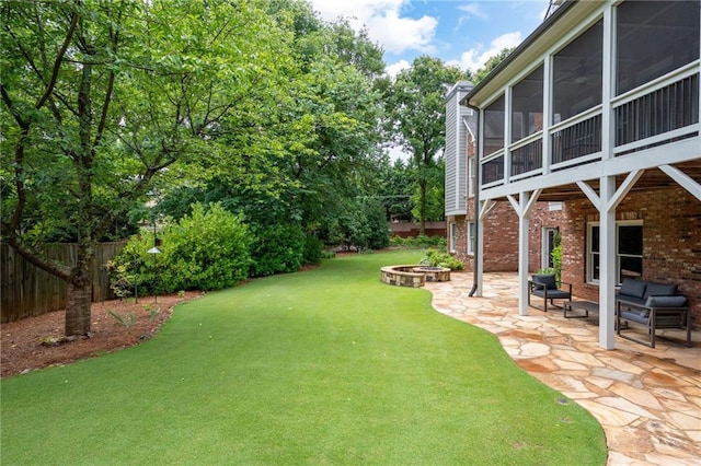 2260 Falkirk Pointe Dr, Marietta, GA 30062 - fenced backyard featuring a fire pit, a patio area, and a sunroom