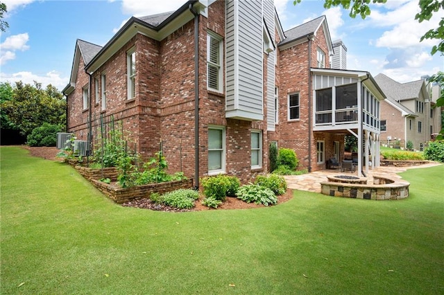 2260 Falkirk Pointe Dr, Marietta, GA 30062 - back of house with a patio area, brick siding, a sunroom, and a yard