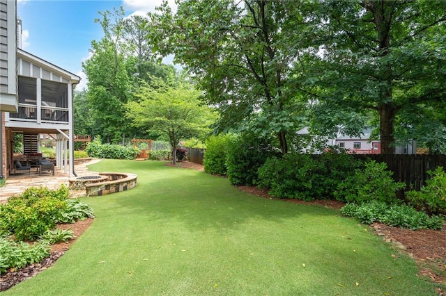 2260 Falkirk Pointe Dr, Marietta, GA 30062 - fenced backyard with a patio area, a fire pit, and a sunroom
