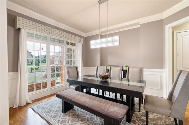 2260 Falkirk Pointe Dr, Marietta, GA 30062 - dining room with ornamental molding, wood finished floors, a wainscoted wall, and a decorative wall