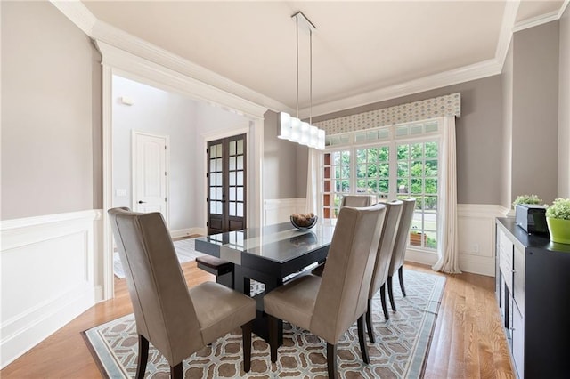 2260 Falkirk Pointe Dr, Marietta, GA 30062 - dining room featuring a wainscoted wall, light wood-style floors, crown molding, a decorative wall, and french doors