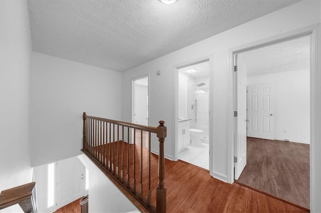 1410 Kingfield Dr, Johns Creek, GA 30005 - hall with wood finished floors, an upstairs landing, and a textured ceiling