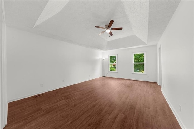 1410 Kingfield Dr, Johns Creek, GA 30005 - unfurnished room with a tray ceiling, ceiling fan, wood finished floors, and a textured ceiling