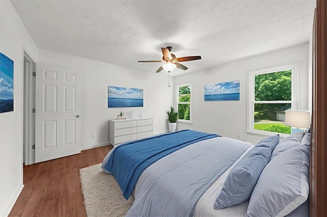 1410 Kingfield Dr, Johns Creek, GA 30005 - bedroom with wood finished floors, a textured ceiling, and a ceiling fan