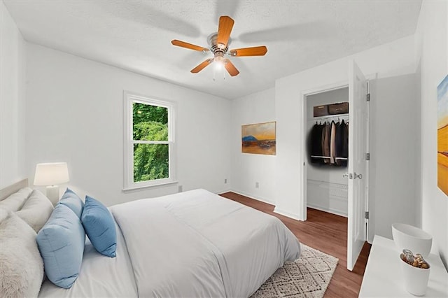 1410 Kingfield Dr, Johns Creek, GA 30005 - bedroom featuring wood finished floors, a walk in closet, a ceiling fan, and a closet