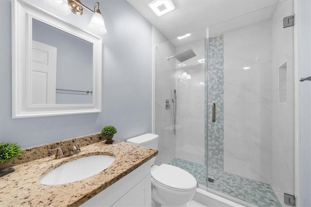 1410 Kingfield Dr, Johns Creek, GA 30005 - bathroom featuring a shower stall, vanity, and a textured ceiling