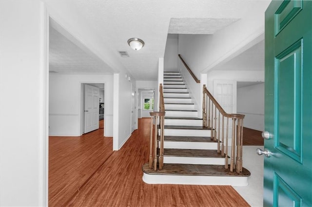 1410 Kingfield Dr, Johns Creek, GA 30005 - stairway featuring wood finished floors and a textured ceiling