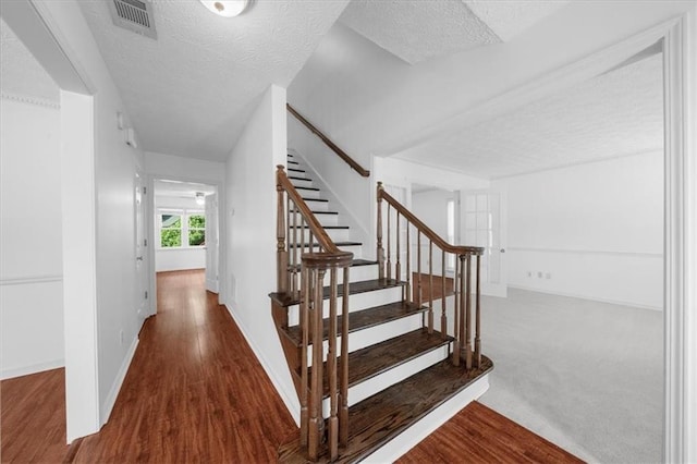 1410 Kingfield Dr, Johns Creek, GA 30005 - stairway with a textured ceiling and wood finished floors