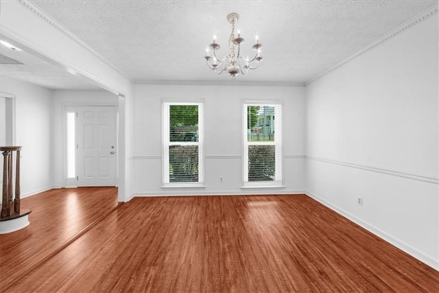 1410 Kingfield Dr, Johns Creek, GA 30005 - unfurnished dining area featuring a chandelier, wood finished floors, a textured ceiling, and ornamental molding