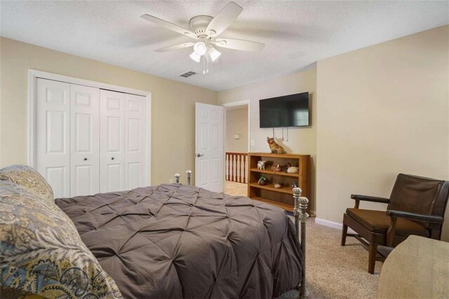 bedroom with carpet flooring, a closet, and ceiling fan