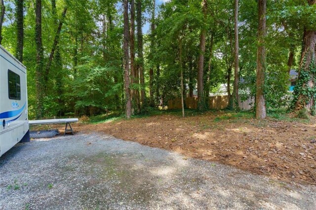 view of property's community with a patio area, a gazebo, an outdoor fire pit, and a yard