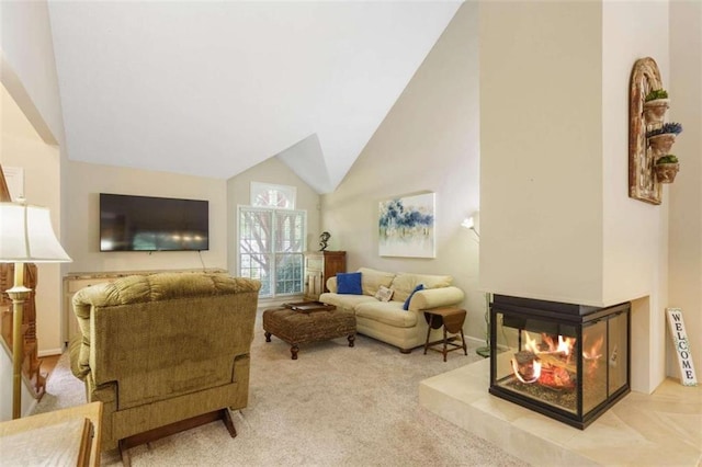 carpeted living room with high vaulted ceiling and a multi sided fireplace