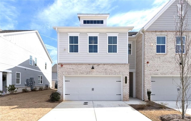 view of front facade with concrete driveway, brick siding, and an attached garage