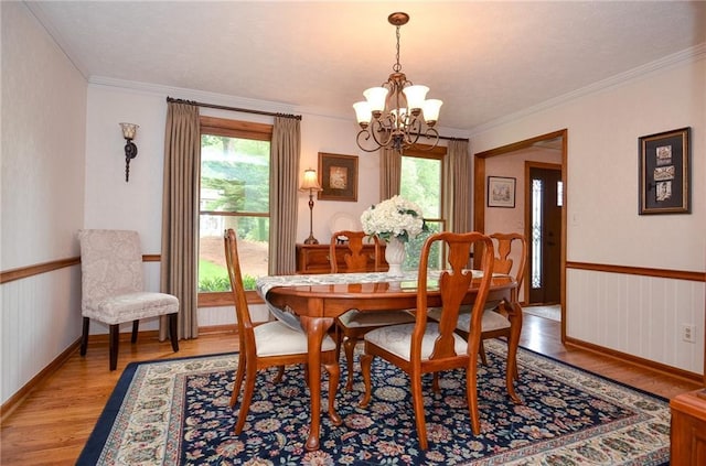 4366 Cedar Wood Dr SW, Lilburn, GA 30047 - dining space featuring a chandelier, light wood finished floors, crown molding, and baseboards