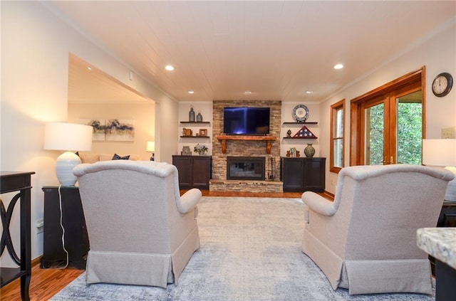 4366 Cedar Wood Dr SW, Lilburn, GA 30047 - living area with a large fireplace, wood finished floors, built in shelves, recessed lighting, and baseboards