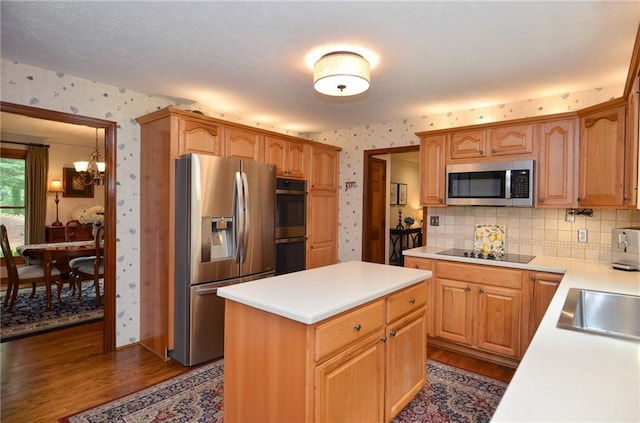 4366 Cedar Wood Dr SW, Lilburn, GA 30047 - kitchen featuring stainless steel appliances, wallpapered walls, dark wood-type flooring, light countertops, and a chandelier