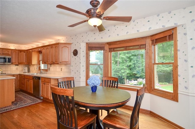 4366 Cedar Wood Dr SW, Lilburn, GA 30047 - dining room featuring wallpapered walls, light wood-style flooring, plenty of natural light, and ceiling fan