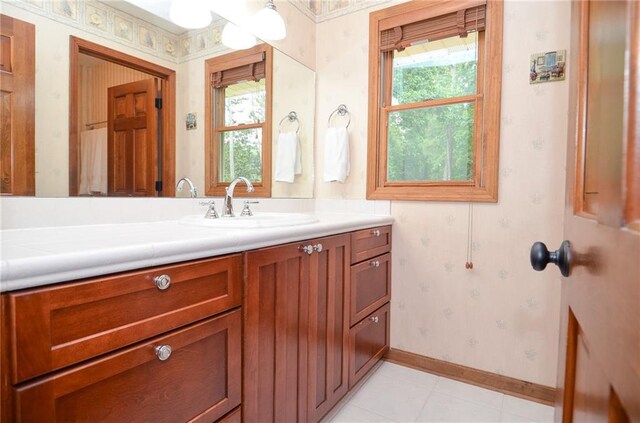 4366 Cedar Wood Dr SW, Lilburn, GA 30047 - bathroom with wallpapered walls, vanity, baseboards, and tile patterned floors