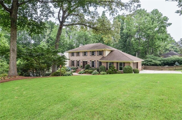 4366 Cedar Wood Dr SW, Lilburn, GA 30047 - colonial-style house with driveway and a garage