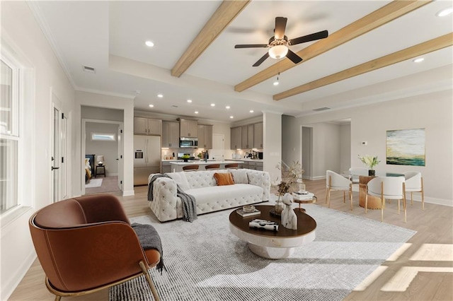 living room featuring light wood finished floors, baseboards, visible vents, beamed ceiling, and recessed lighting