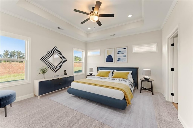 carpeted bedroom featuring recessed lighting, visible vents, baseboards, a tray ceiling, and crown molding