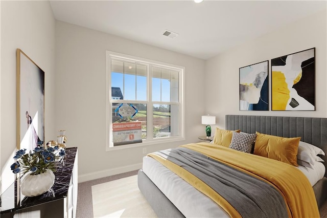 bedroom with carpet flooring, visible vents, and baseboards