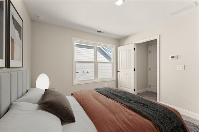 carpeted bedroom with visible vents and baseboards