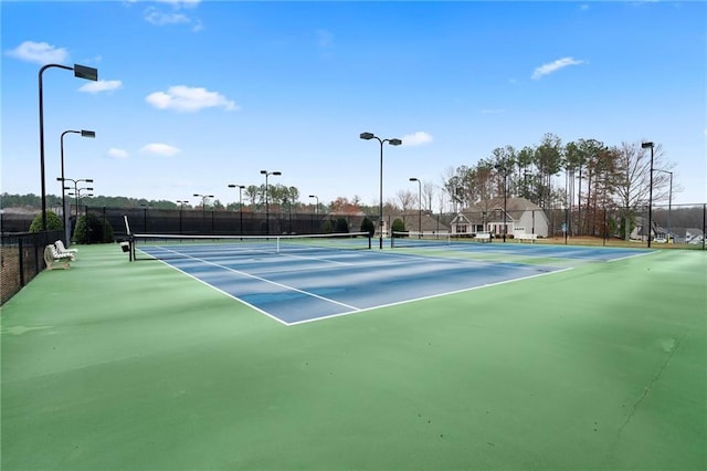 view of sport court featuring fence