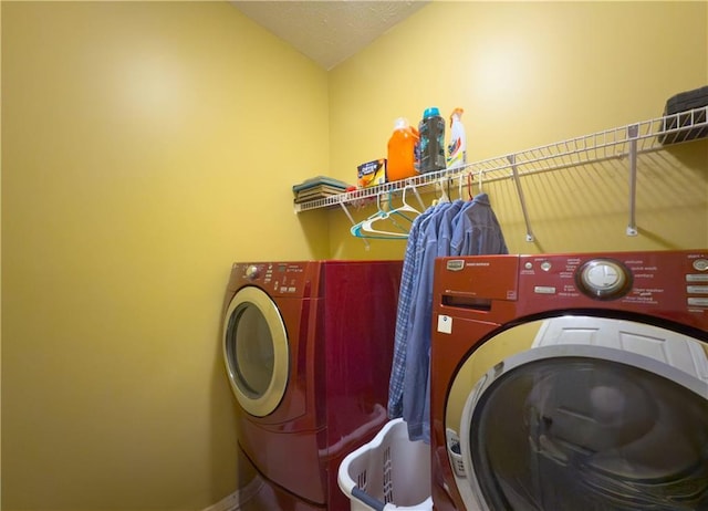 clothes washing area featuring washing machine and dryer and laundry area