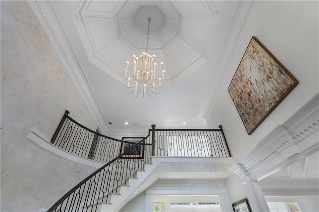 stairs featuring crown molding, recessed lighting, a high ceiling, and a notable chandelier