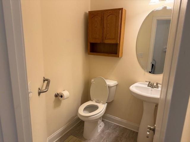 240 Huiet Dr, Mcdonough, GA 30252 - half bath with baseboards, toilet, a sink, and wood finished floors