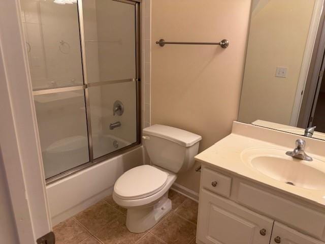 240 Huiet Dr, Mcdonough, GA 30252 - bathroom featuring toilet, vanity, tile patterned flooring, and enclosed tub / shower combo
