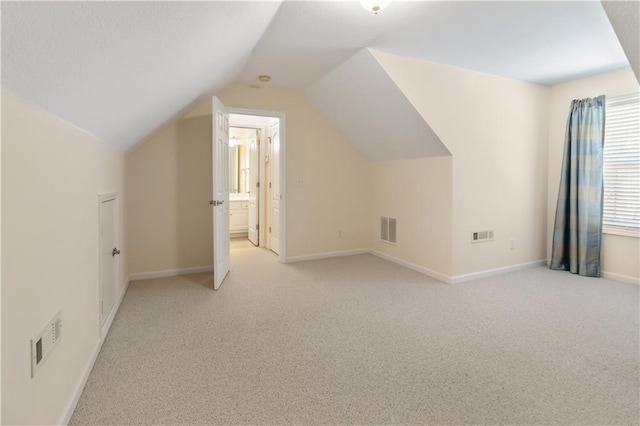 240 Huiet Dr, Mcdonough, GA 30252 - bonus room with light colored carpet, vaulted ceiling, and baseboards