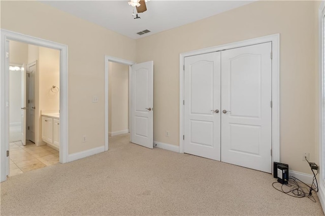 240 Huiet Dr, Mcdonough, GA 30252 - unfurnished bedroom featuring light colored carpet, a closet, baseboards, ensuite bath, and ceiling fan