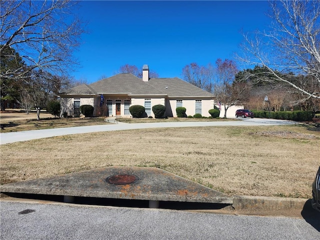 view of front of house with a front lawn and a chimney