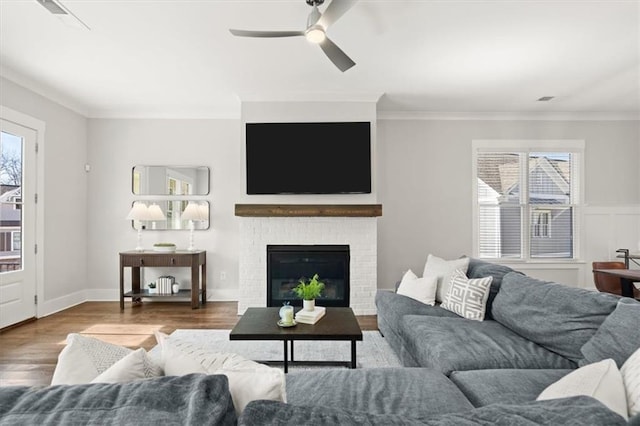 2005 Haley Walk, Woodstock, GA 30188 - living room featuring a ceiling fan, ornamental molding, wood finished floors, and a brick fireplace