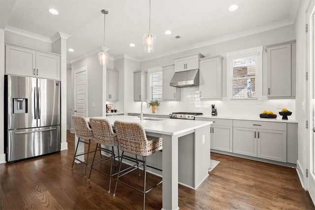 2005 Haley Walk, Woodstock, GA 30188 - kitchen with stainless steel refrigerator with ice dispenser, under cabinet range hood, plenty of natural light, ornamental molding, and an island with sink
