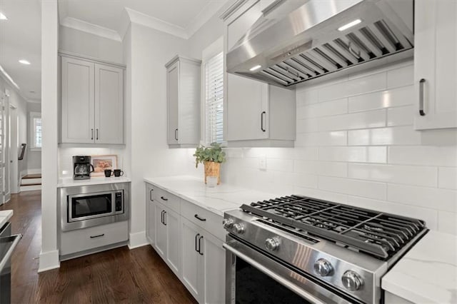 2005 Haley Walk, Woodstock, GA 30188 - kitchen with stainless steel appliances, wall chimney exhaust hood, crown molding, tasteful backsplash, and light stone counters