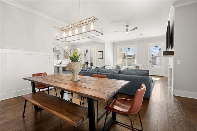 2005 Haley Walk, Woodstock, GA 30188 - dining area with ceiling fan, ornamental molding, dark wood-style flooring, a decorative wall, and wainscoting