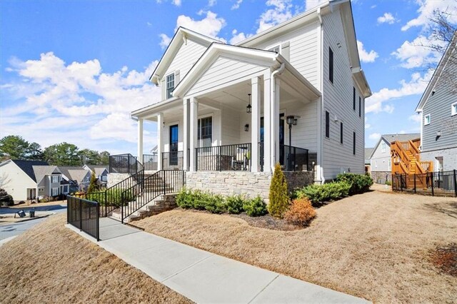 2005 Haley Walk, Woodstock, GA 30188 - view of front of home with a porch, a residential view, and fence