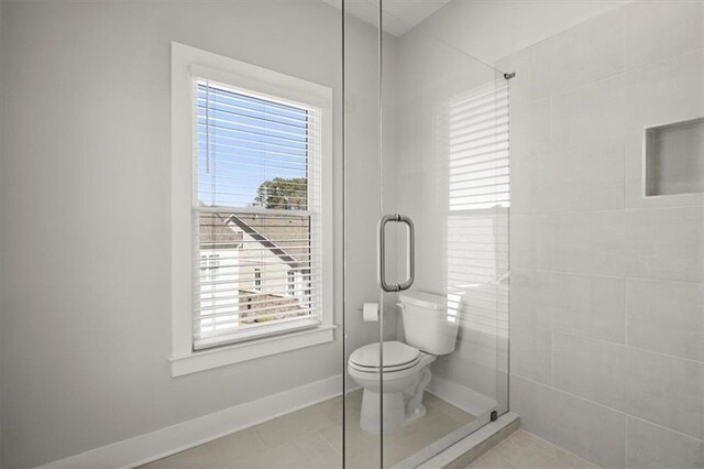 2005 Haley Walk, Woodstock, GA 30188 - full bath featuring a tile shower, toilet, plenty of natural light, and baseboards